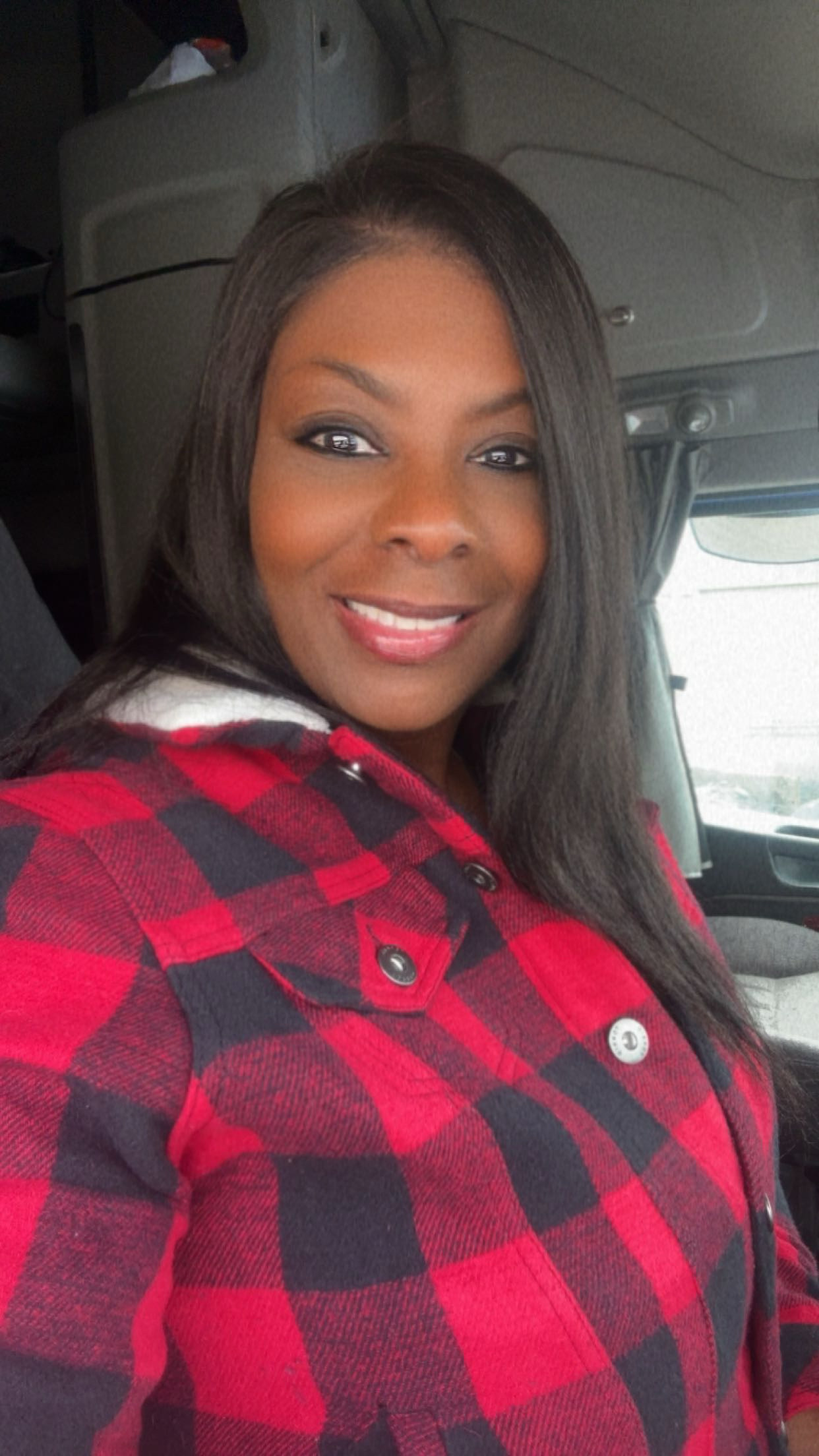 Traci, founder of STARR Quality Logistics, seated inside a working truck